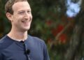 Mark Zuckerberg smiling while wearing a dark shirt during a public appearance.